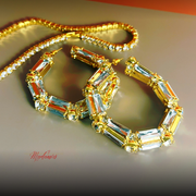 Gold necklace with gemstones on a reflective surface