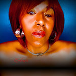 Woman with red hair and jewelry against a blue background