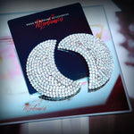 Decorative earrings with rhinestones on a branded card
